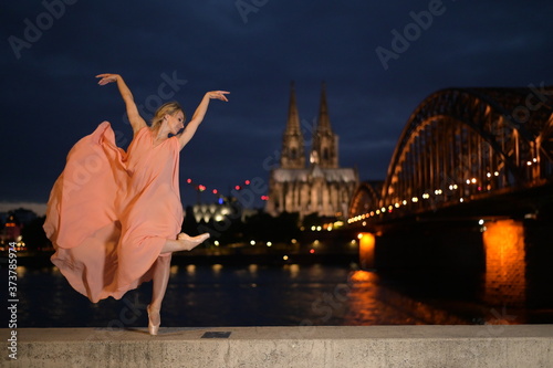 Photography A beautiful ballet dancer ballerina outdoors ,Ballerina dancing on the bridge  in Cologne City