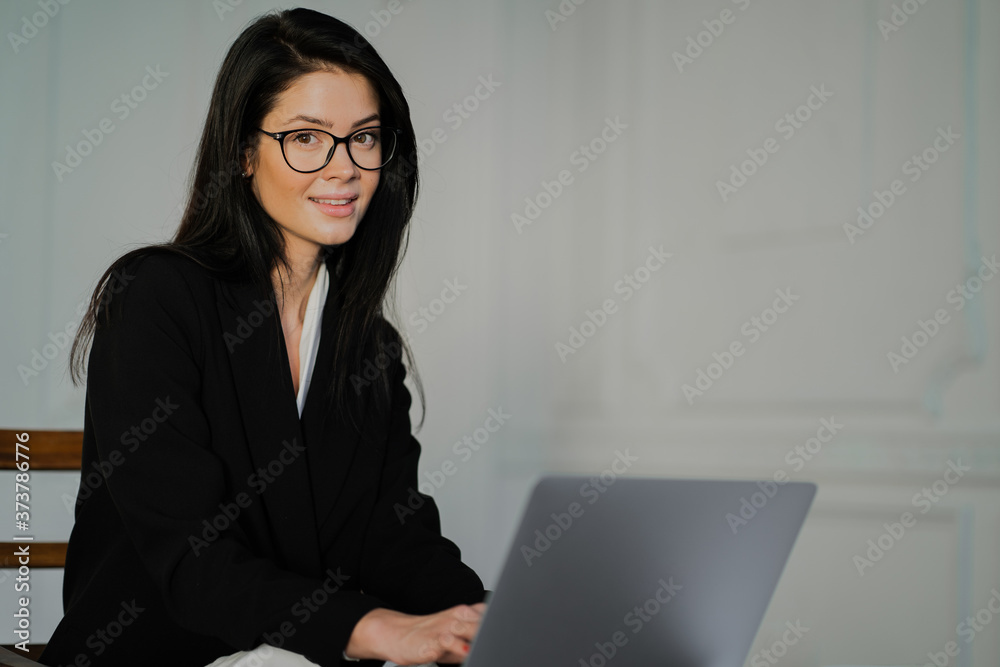 portrait of a young student. the concept of a businesswoman. Glasses on the face for protection from the monitor.