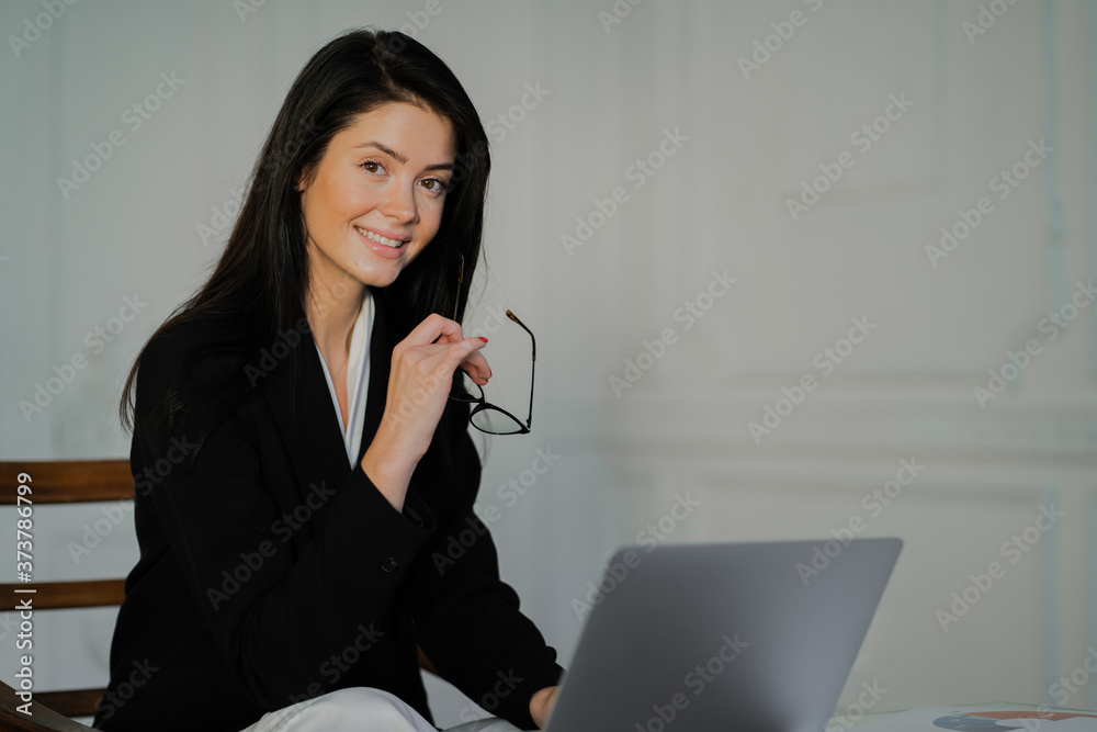 businesswoman working on laptop. the concept of a businesswoman. Glasses on the face for protection from the monitor. businesswoman working on laptop. the concept of a businesswoman. Glasses on the face for protection from the monitor.