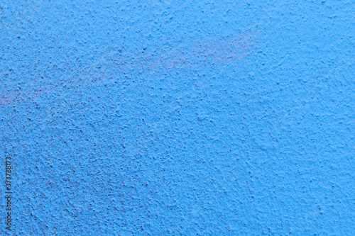 The plaster rough wall is painted blue