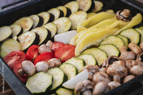 Tray with grilled vegetables in the oven. Selective focus. Low DOF.