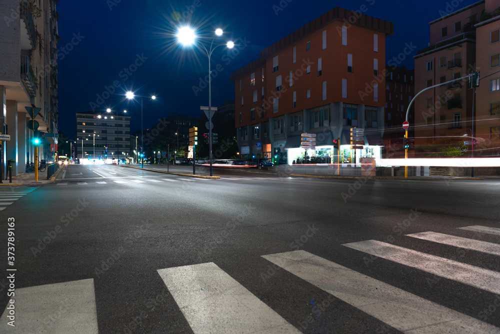 Timelapse view of traffic at an urban night intersection. Urban movement in the Italian city in the evening.