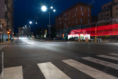 Timelapse view of traffic at an urban night intersection. Urban movement in the Italian city in the evening.