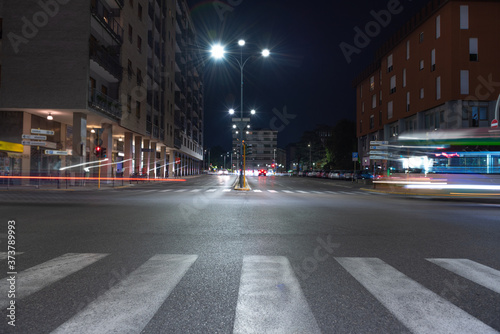 Timelapse view of traffic at an urban night intersection. Urban movement in the Italian city in the evening.