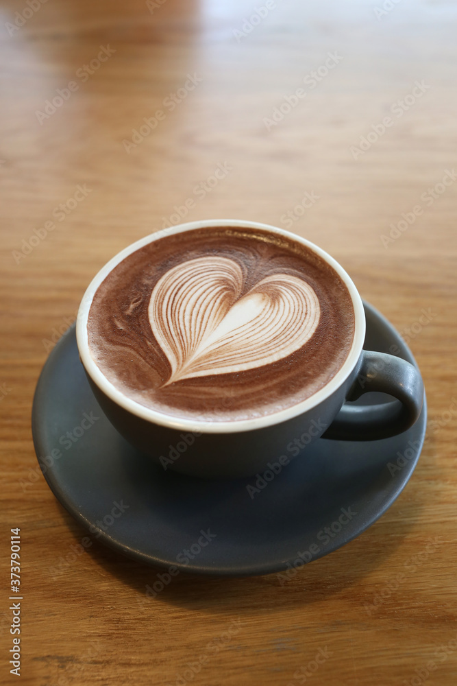 Hot cocoa or chocolate cup that are placed on the wooden table. Hot cocoa or chocolate cup that are placed on the wooden table.