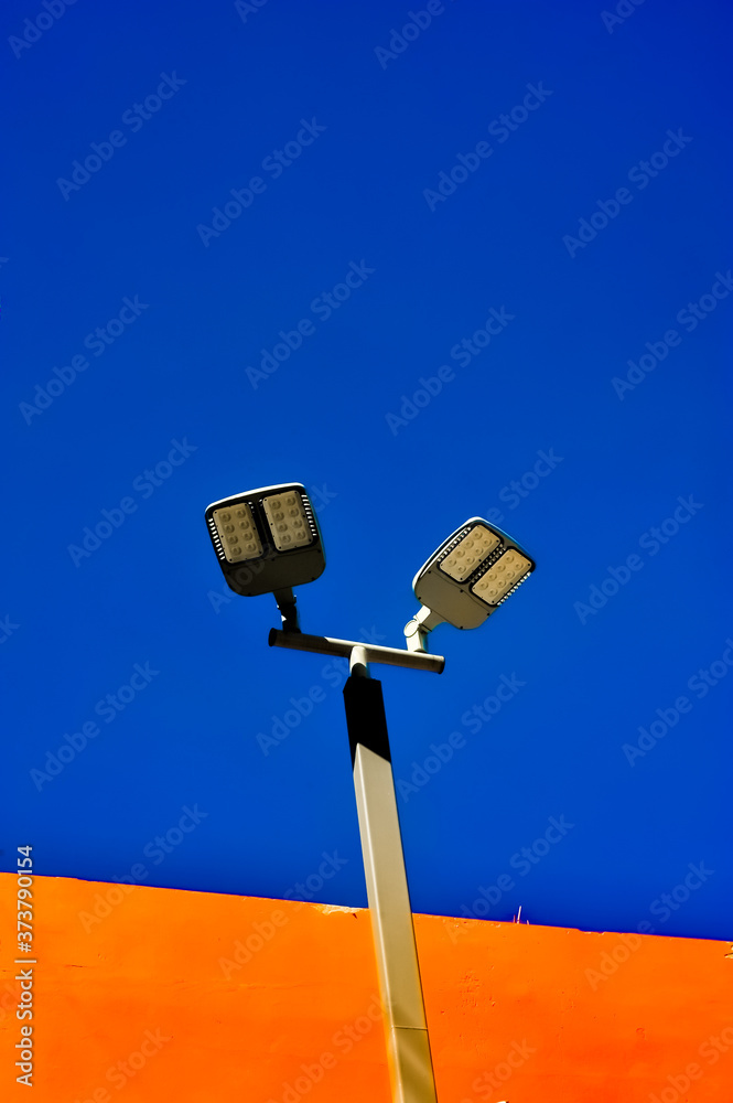 A Lamp pole with Blue and orange background at Rajamangala National Stadium in Bangkok Thailand A Lamp pole with Blue and orange background at Rajamangala National Stadium in Bangkok Thailand