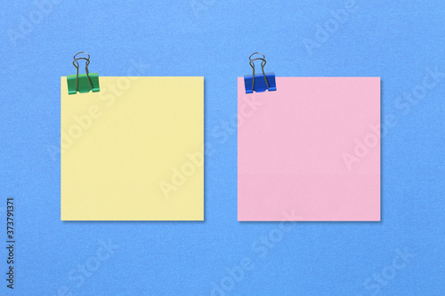 Colorful square note paper on blue paper background.