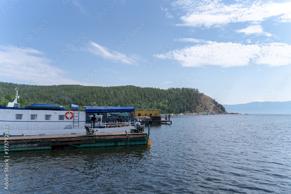Russia, Irkutsk region, Olkhon, July 2020: baikal lake recreations, motor boat with passengers on baikal lake Russia, Irkutsk region, Olkhon, July 2020: baikal lake recreations, motor boat with passengers on baikal lake