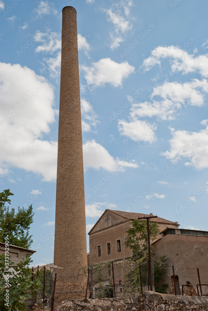 Athens, Greece / May 2021: Chimney at abandoned 1800's cognac distillery in Athens.