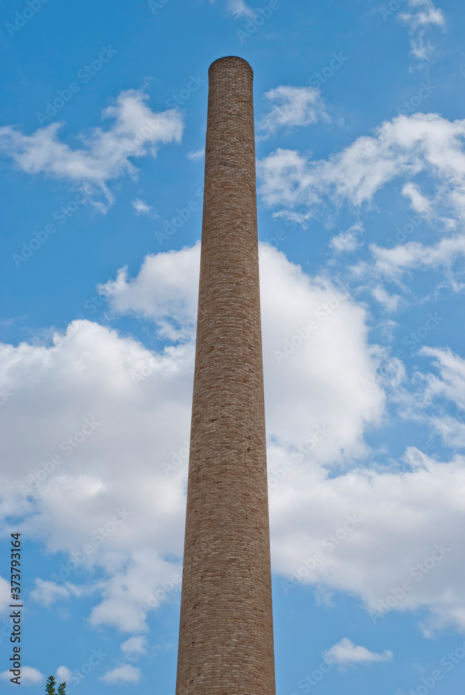 Athens, Greece / May 2021: Chimney at abandoned 1800's cognac distillery in Athens.