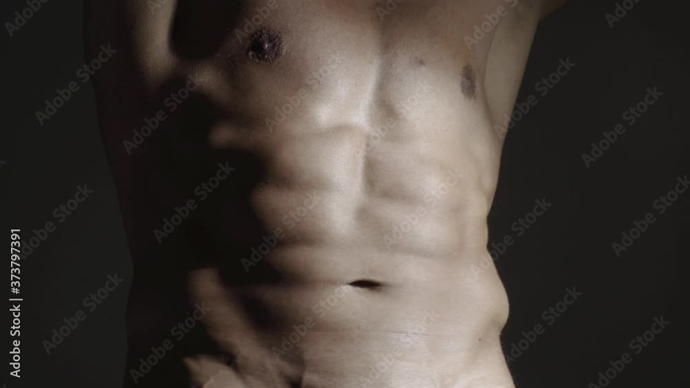 Fashion brutal naked guy. Muscular mens abdomen, chest, men abs, six pack. Sexy man with muscular body and bare torso. Gay and lgbt concept.