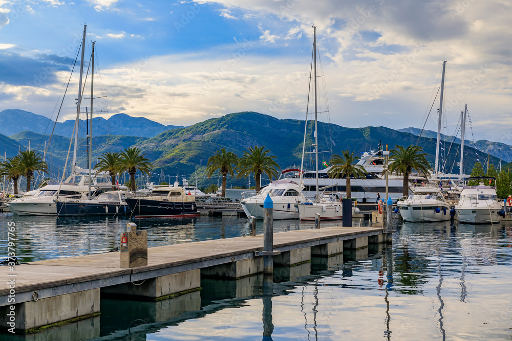Scenic view of the Adriatic Sea marina with boats and mountains in the background in Tivat Montenegro