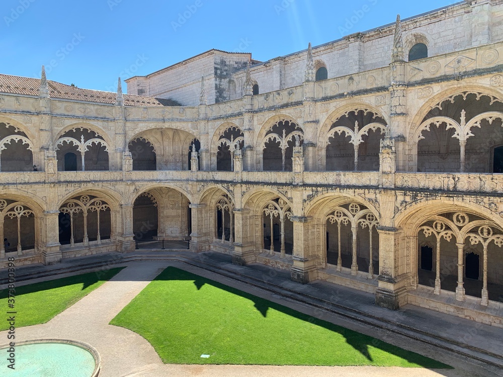 Inside the beautiful Hieronymites Monastery of Jeronimos with the beautiful green garden in Belem, Lisbon, Portugal