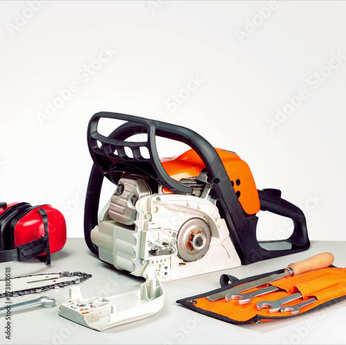 Concept repair chainsaw and gasoline powered tools. Chainsaw and tools at workbench .