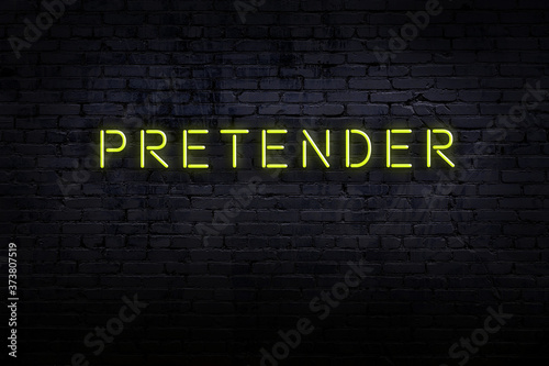 Bilde på lerret Night view of neon sign on brick wall with inscription pretender
