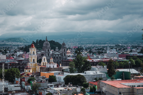 Urban landscape of the City of Toluca, Mexico, where you can see several of the emblematic sites such as the Cathedral, the Cerro del Calvario, a traditional Mexican multicolored panorama.
