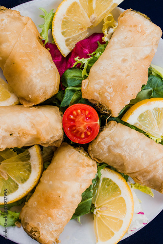 spinach and cheese patty rolls, middle eastern food vertical image. Original name is Sigara Borek or bourak photo