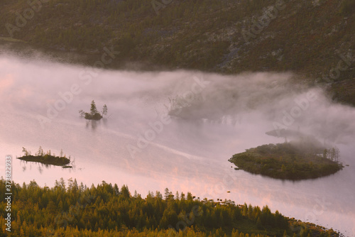 Fog over the Islands of the mountain lake