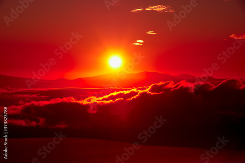 真っ赤な太陽と雲。津別峠、北海道。Abstract of sunrise and sunset with red shining sun and clouds. Tsubetsu-pass,hokkaido,japan.