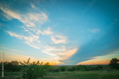 Shelf cloud spans over Texan landscape at sunset.