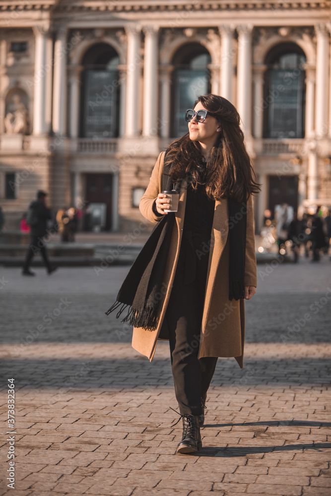 portrait of stylish gorgeous woman in coat outdoors drinking coffee to go portrait of stylish gorgeous woman in coat outdoors drinking coffee to go