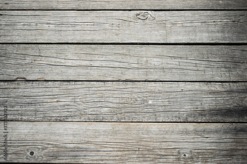 Fototapeta premium the background consists of narrow wooden strips of gray color arranged horizontally
