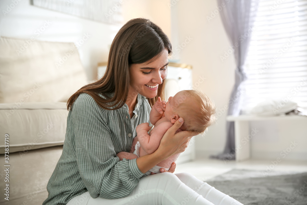 Mother with her newborn baby at home