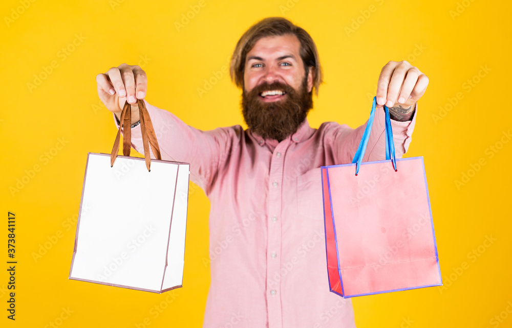 cheerful brutal hipster hold gift. paper shopping bag. birthday surprise at party. man with package. prepare for holidays. best sale offer. happy bearded man with present pack. Online shop cheerful brutal hipster hold gift. paper shopping bag. birthday surprise at party. man with package. prepare for holidays. best sale offer. happy bearded man with present pack. Online shop