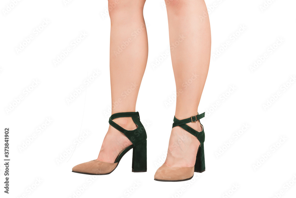 Woman legs in green and beige sandals on heels. Woman legs in green and beige sandals on heels.