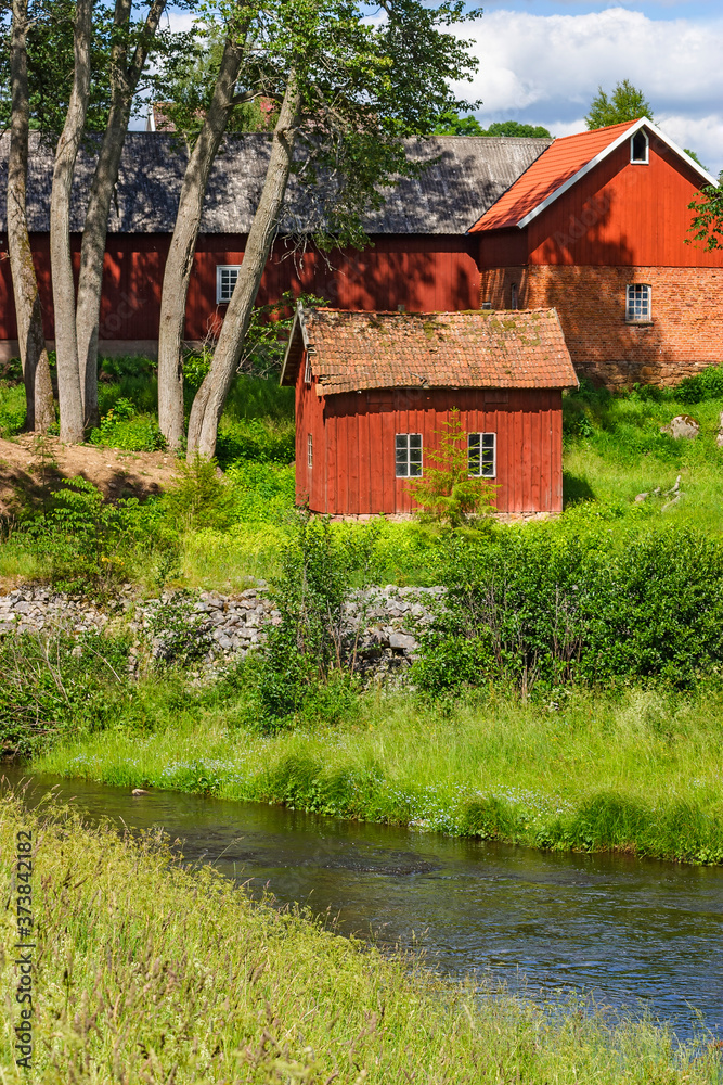 Farm by a river in a beautiful rural landscape Farm by a river in a beautiful rural landscape