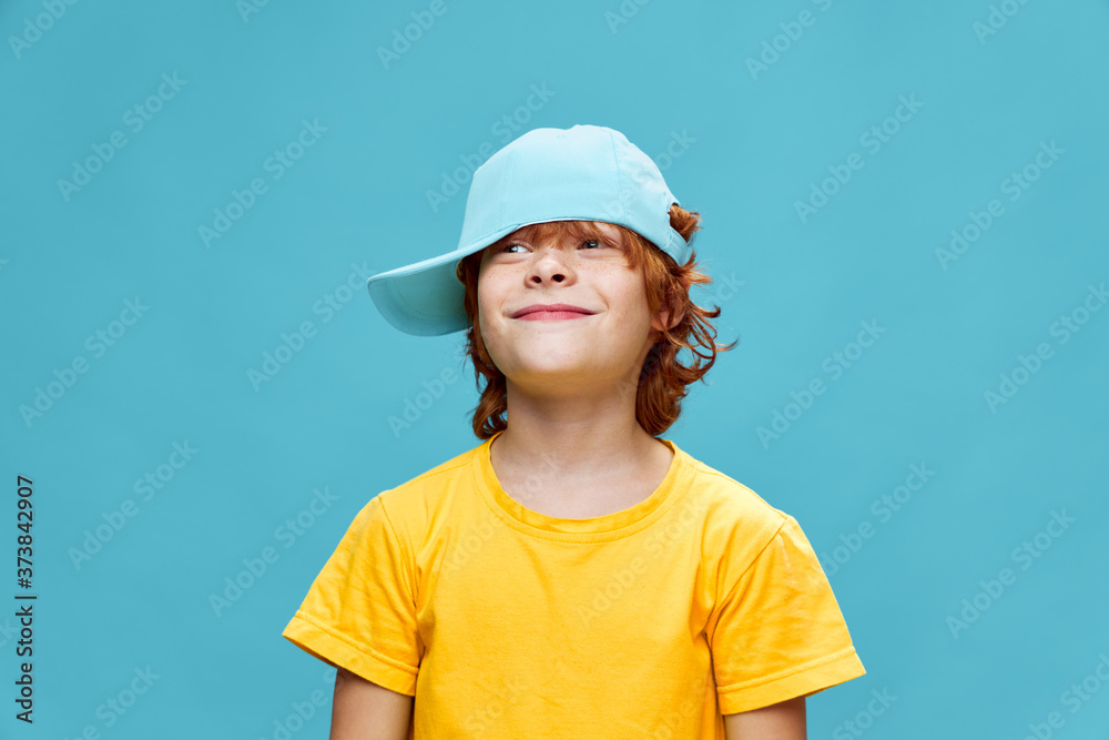 Child with a cap on his head and red hair smiling Child with a cap on his head and red hair smiling