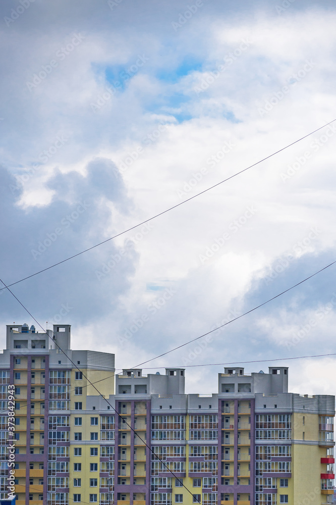 View of a multi-storey building through a network of communication cables View of a multi-storey building through a network of communication cables