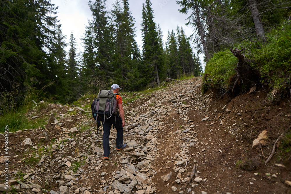 Man with two backpacks hiking Man with two backpacks hiking