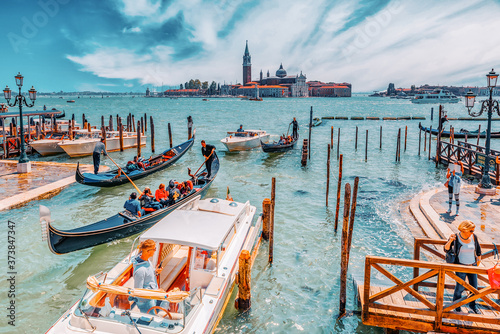 VENICE, ITALY - MAY 12, 2017 : Embankment of the Grand Canal with Gondolas and Gondoliers. Italy. photo