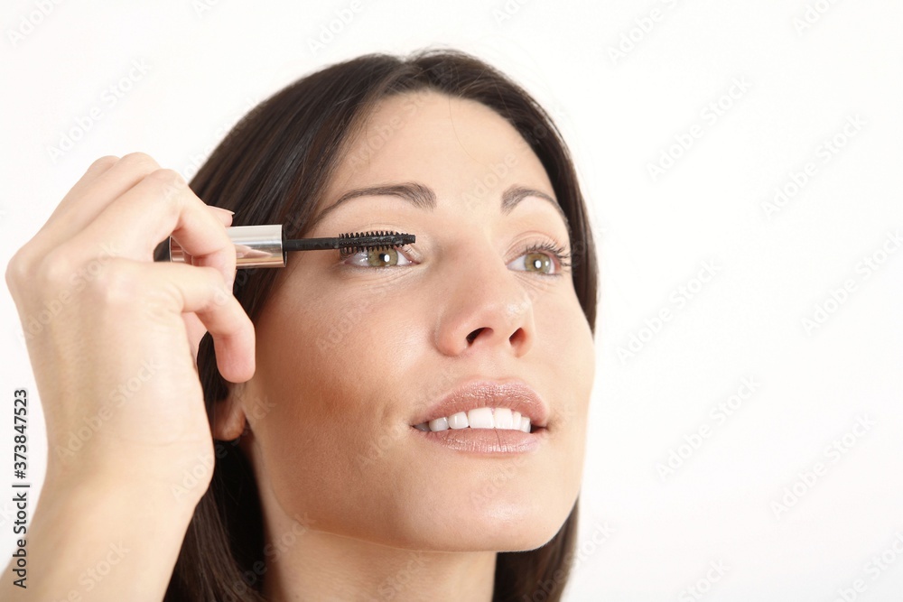 Woman applying mascara