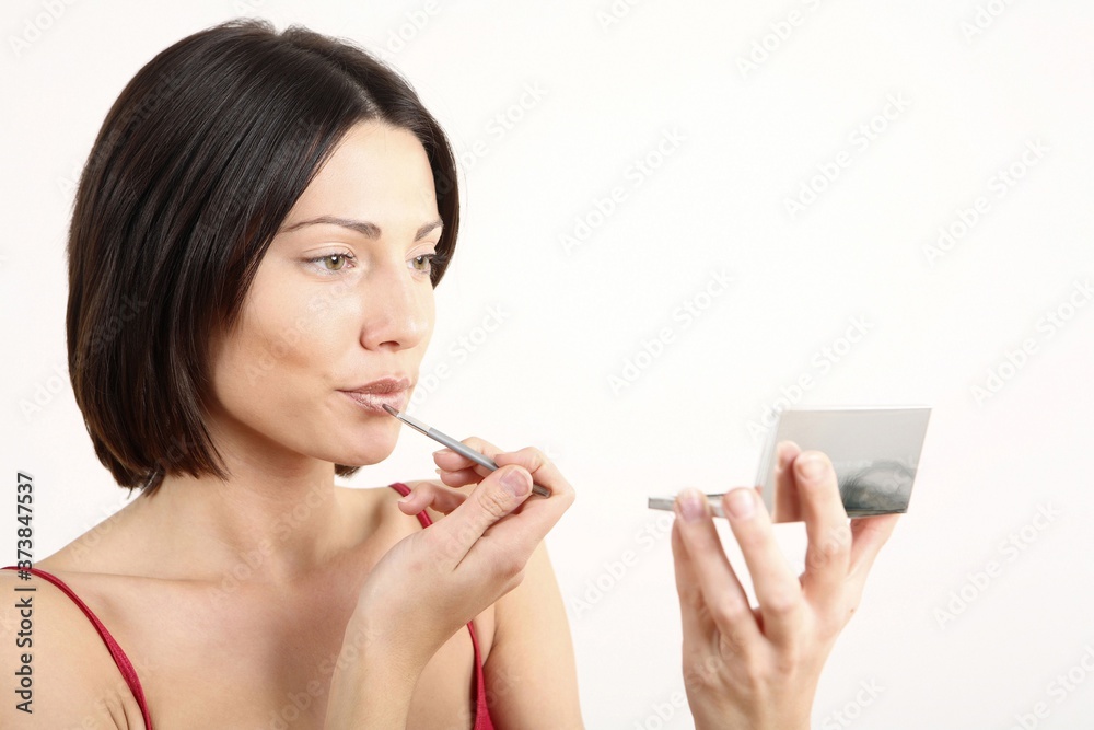 Woman colouring her lips