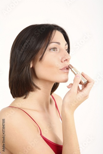 Woman applying lipstick