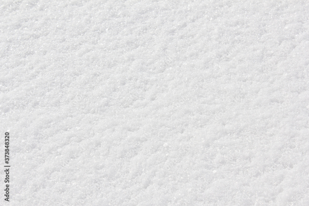 Texture of fresh snow covering the ground in winter .