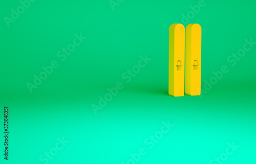 Orange Ski and sticks icon isolated on green background. Extreme sport. Skiing equipment. Winter sports icon. Minimalism concept. 3d illustration 3D render.