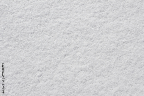 Texture of fresh snow covering the ground in winter .