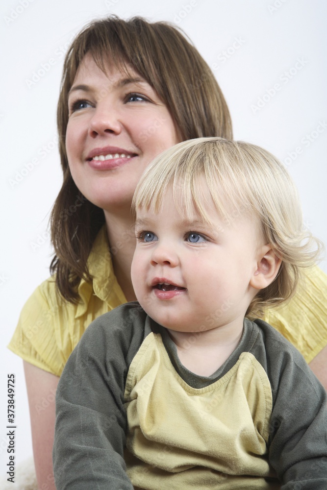 Mother and son smiling while looking away Mother and son smiling while looking away