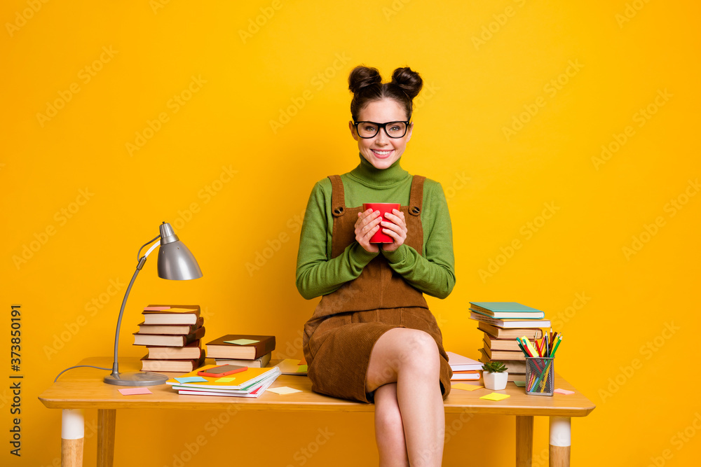 Photo of positive cheerful girl hold coffee cup enjoy education lesson break pause wear green pullover overall skirt isolated over bright shine color background Photo of positive cheerful girl hold coffee cup enjoy education lesson break pause wear green pullover overall skirt isolated over bright shine color background
