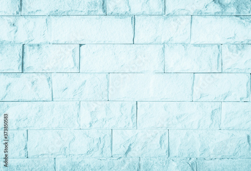 Empty Background of wide blue brick wall texture. Pastel brick wall texture background in room at subway. Brickwork stonework interior, rock old concrete grid uneven horizontal architecture wallpaper.