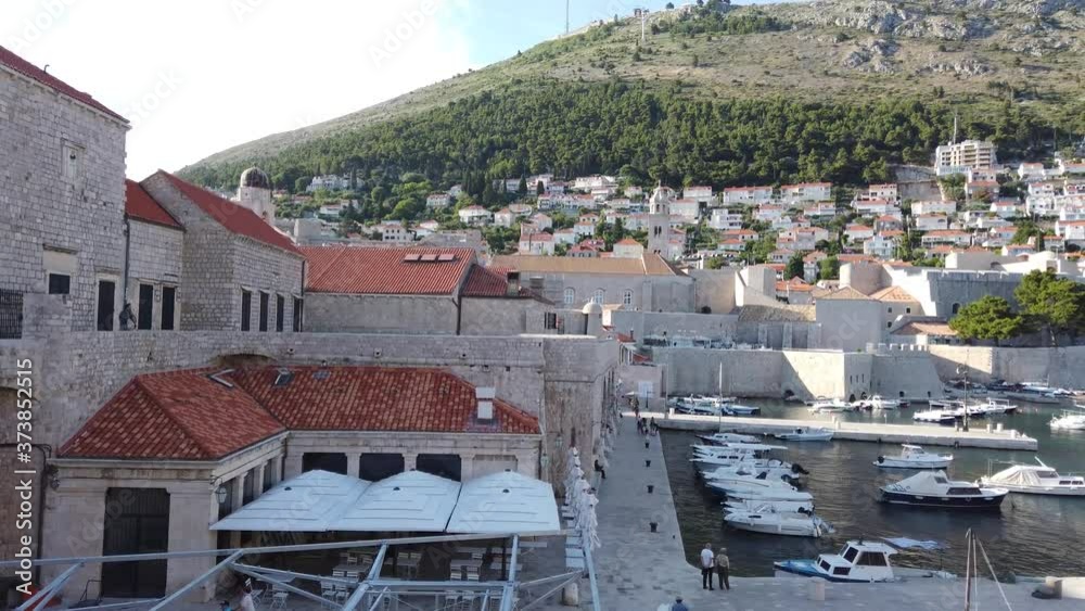 Old town of Dubrovnik with its old port full of boats. Porporela - pier and breakwater in Dubrovnik Old Harbour. Dubrovnik, Mediterranean Sea, Croatia. Old town of Dubrovnik with its old port full of boats. Porporela - pier and breakwater in Dubrovnik Old Harbour. Dubrovnik, Mediterranean Sea, Croatia.