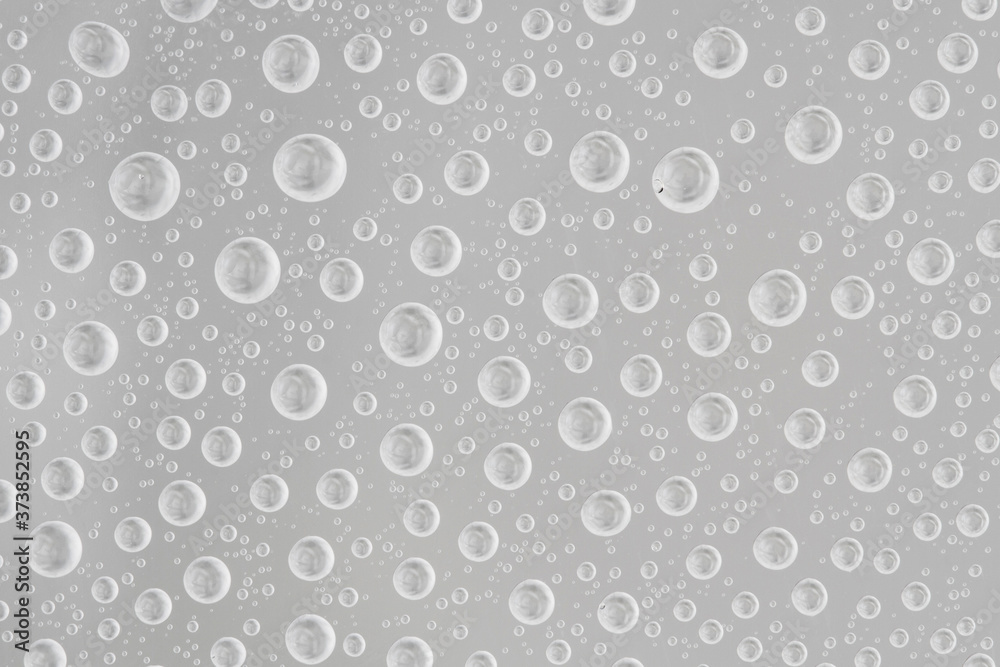Water drops on gray background. Top view. Closeup. Water drops on gray background. Top view. Closeup.