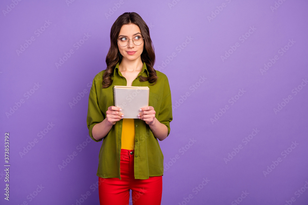 Portrait of minded thoughtful girl hipster hold note book think thoughts decide subject diary project wear style stylish trendy red pants trousers isolated violet color background Portrait of minded thoughtful girl hipster hold note book think thoughts decide subject diary project wear style stylish trendy red pants trousers isolated violet color background