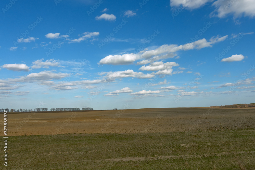 Beautiful cloudy sky over farmland. Spring landscape. Beautiful cloudy sky over farmland. Spring landscape.