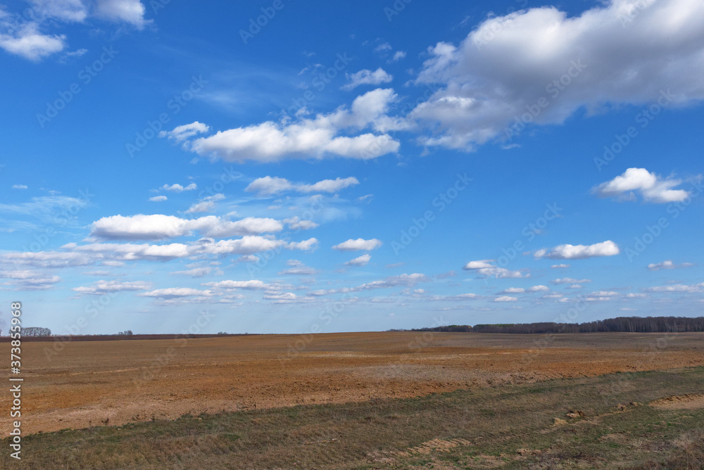 Beautiful cloudy sky over farmland. Spring landscape. Beautiful cloudy sky over farmland. Spring landscape.