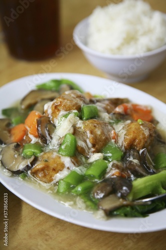 Asian dish of vegetables and a bowl of rice