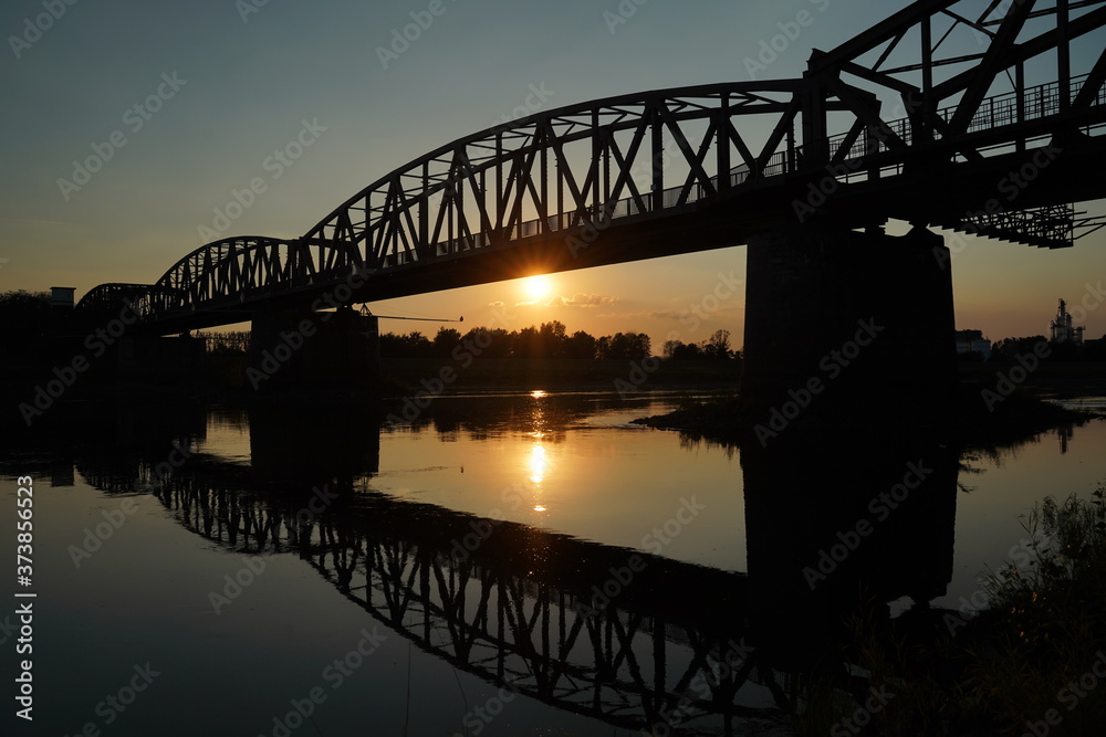 The reflection of the old bridge on the river,The silhouette of the old bridge at sunrise or sunset in the countryside